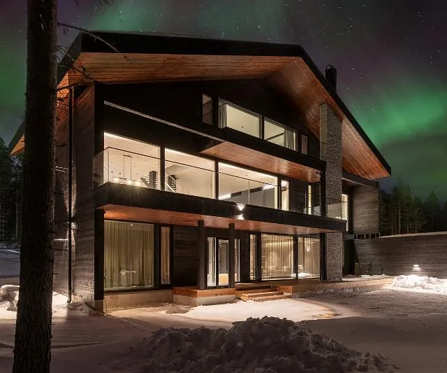 Modern house under northern lights